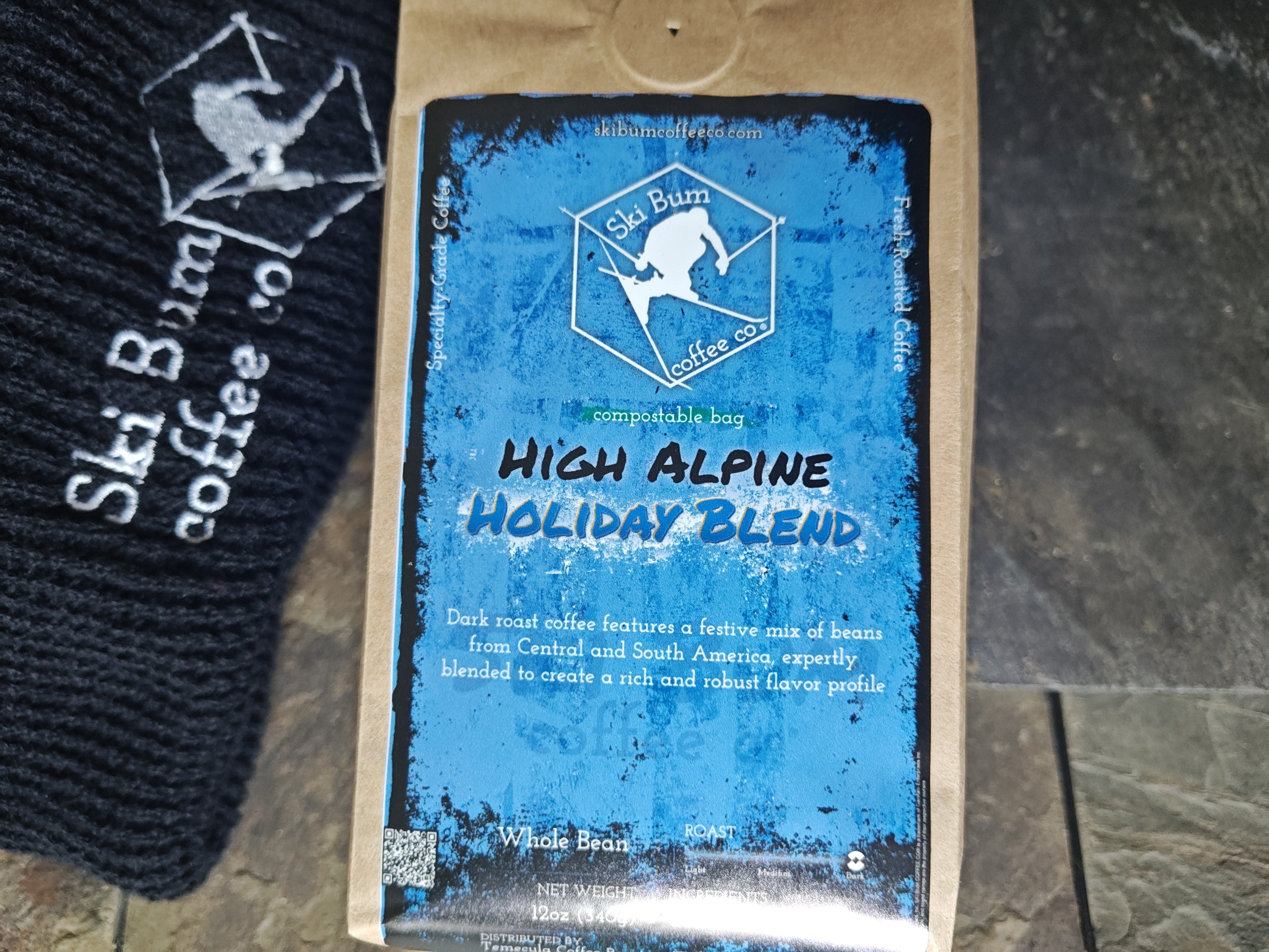 Ski Bum Coffee Co. High Alpine Holiday Blend coffee package on a stone surface