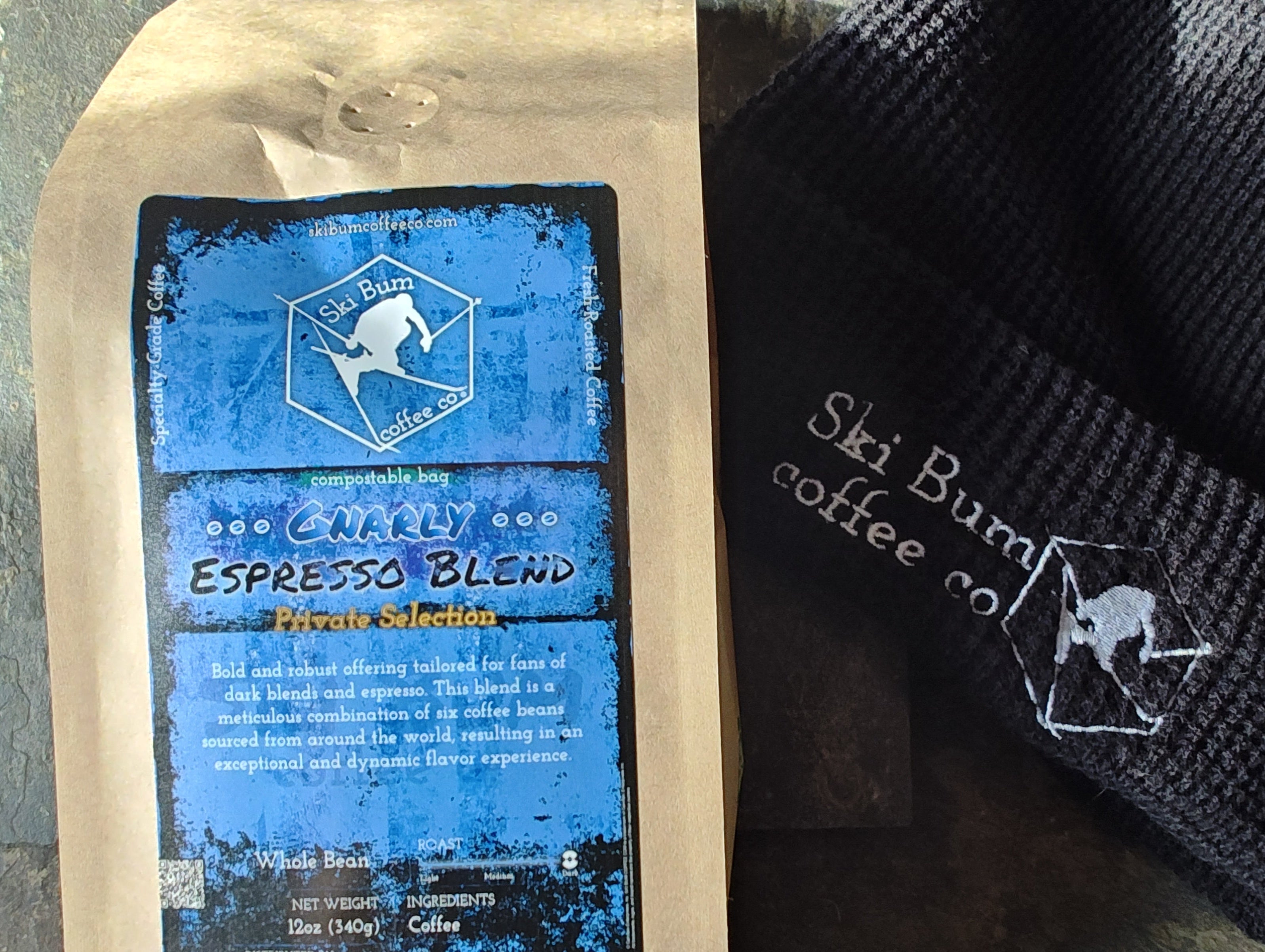 Gnarly Espresso Blend, coffee from Ski Bum Coffee Co, next to a beanie on a stone background