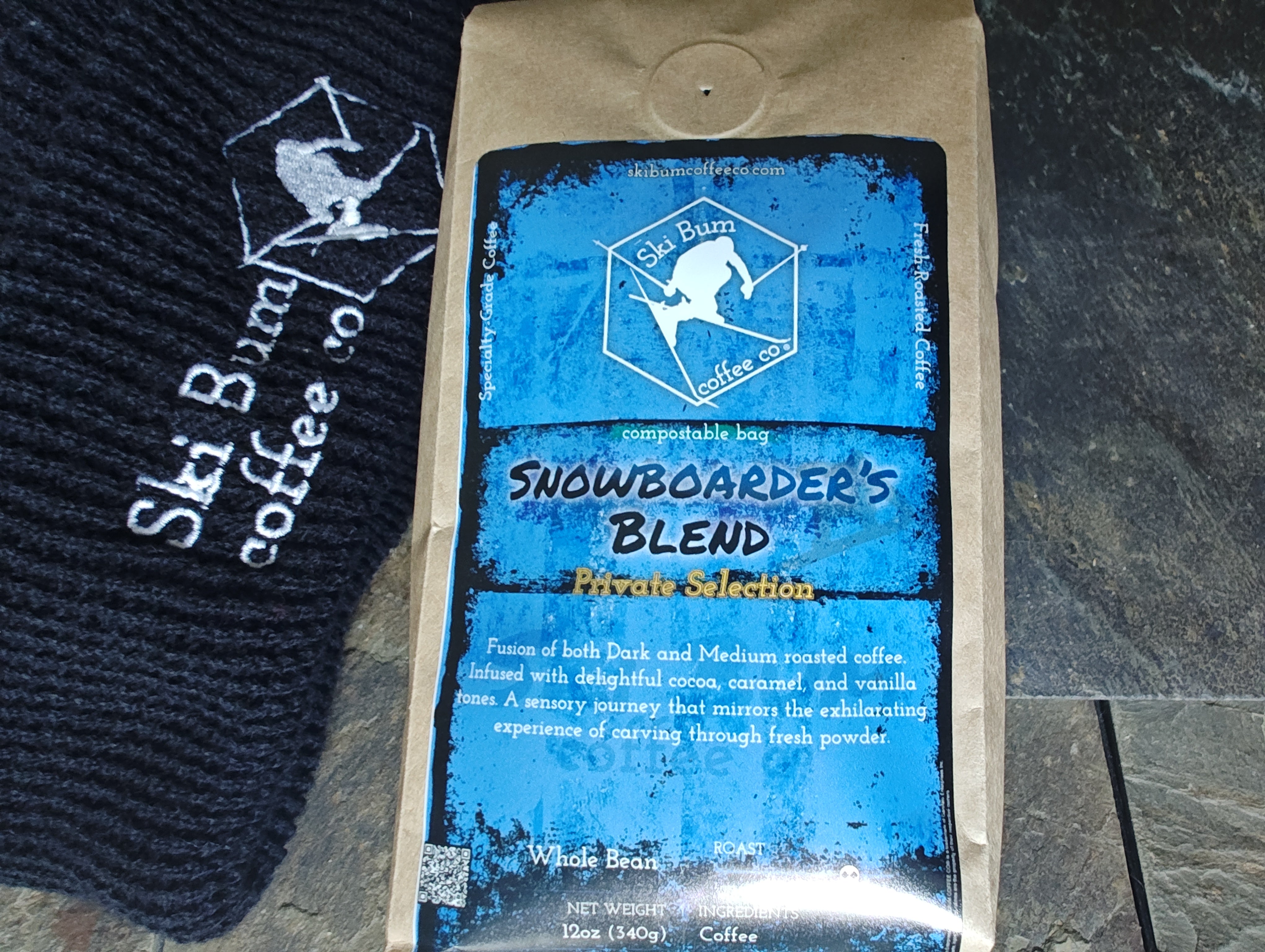 'Snowboarder's Blend' coffee bag by Ski Bum Coffee Co. on a dark surface.