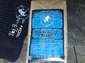 'Snowboarder's Blend' coffee bag by Ski Bum Coffee Co. on a dark surface.
