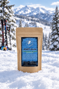 Après Glow Chamomile Ginger tea pouch in a snowy ski mountain scene