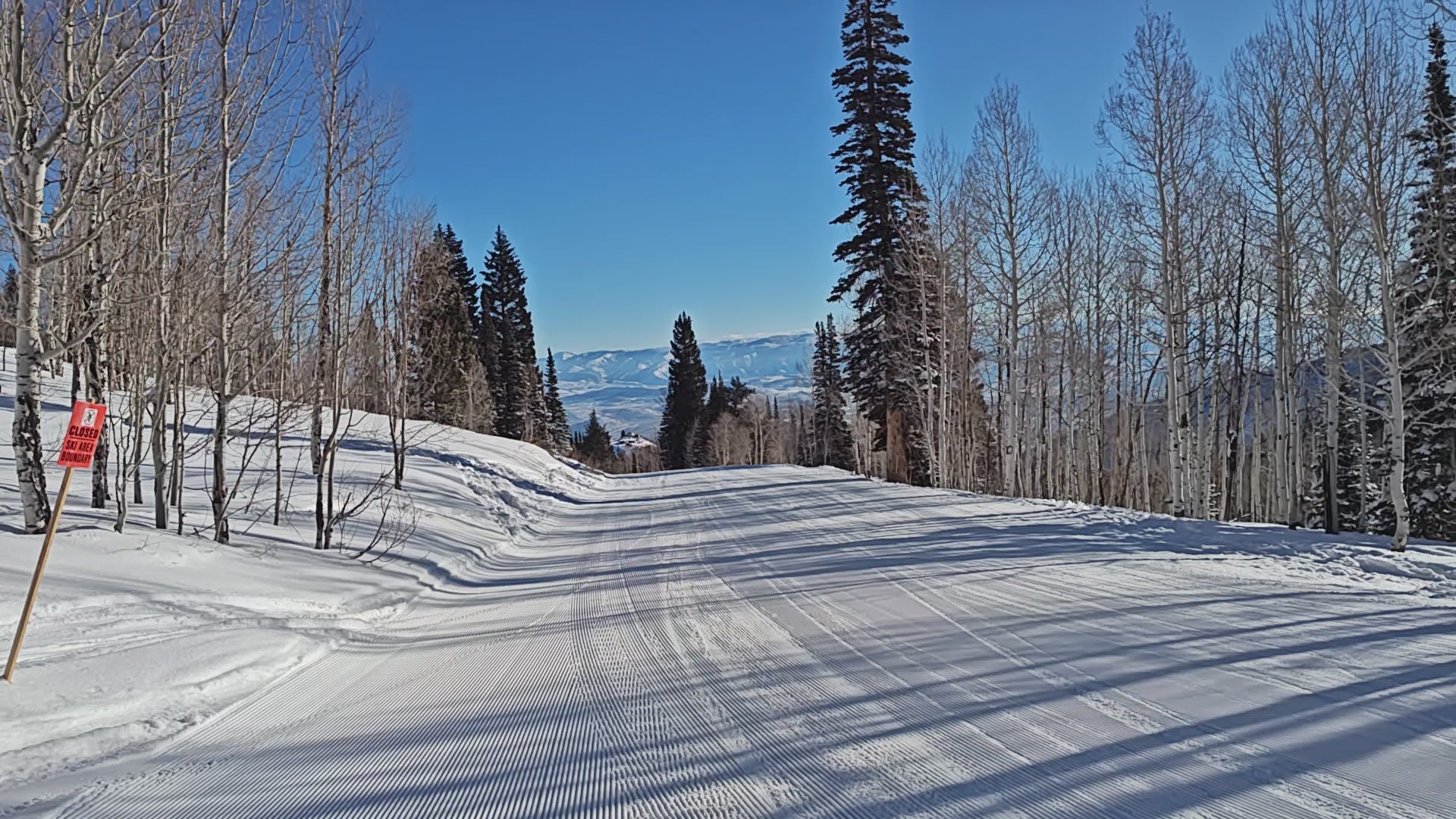 Skiing down a groomed slope