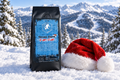 Skiing Santa Candy Cane coffee bag with a Santa hat beside it in a snowy ski mountain scene